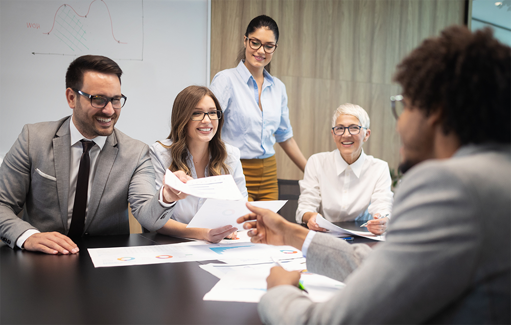 contracts_are_fun A group of people working on documents together