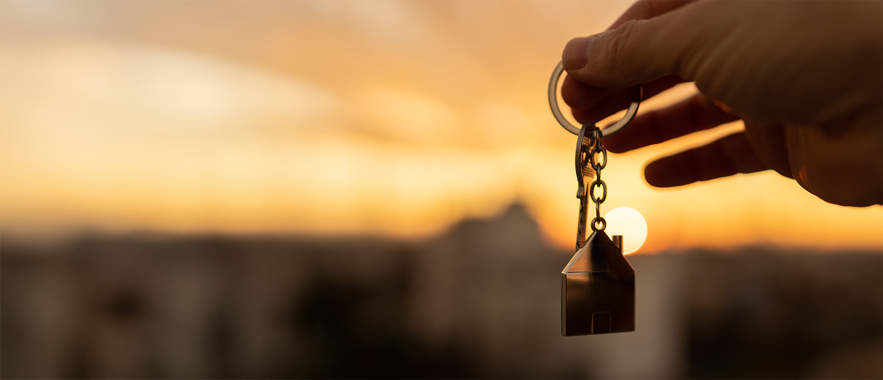 Hand holding keys to a home