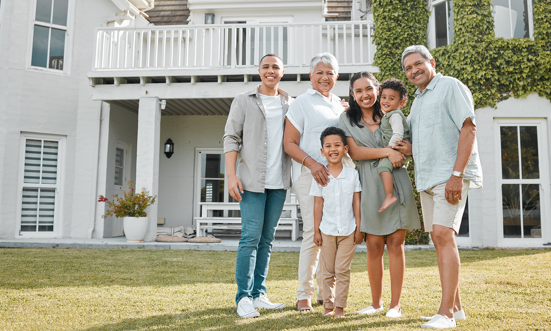 Family standing together outside a home