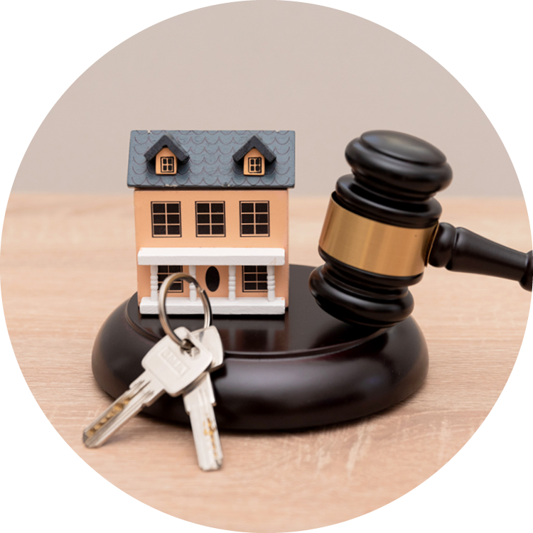 A small model home, keys, and a gavel