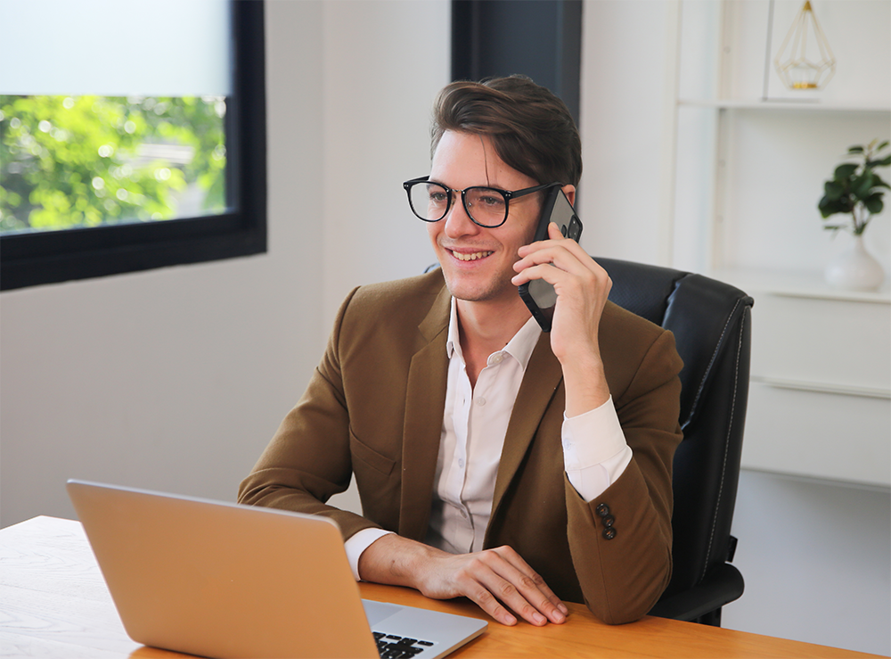A man on a phone at a desk